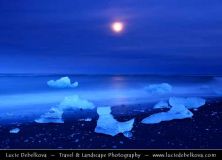 iceland - full moon over pieces of ice at black sand beach near jkulsrln glacier lagoon.jpg